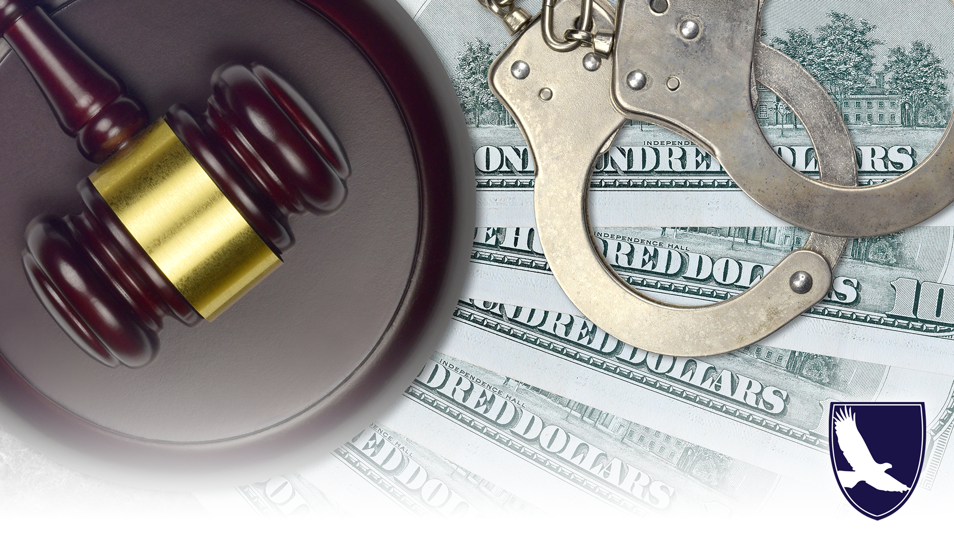 image of money, handcuffs and gavel on a table